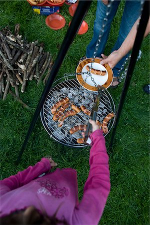 family dinner garden - Girl Serving Sausages from Barbeque Stock Photo - Rights-Managed, Code: 700-02670577