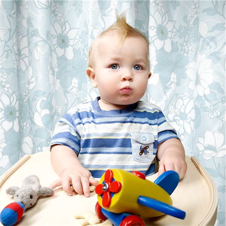 Boy Playing with Toys in High Chair Stock Photo - Rights-Managed, Code: 700-02693923