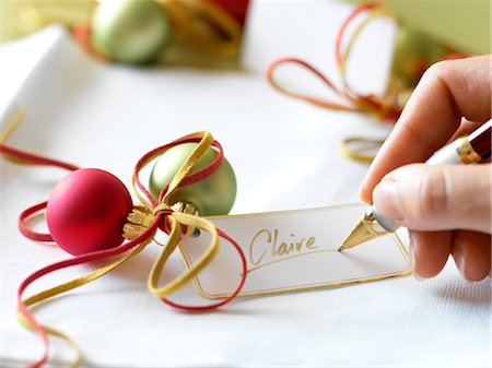 Woman Writing Name on Gift Tag Stock Photo - Rights-Managed, Code: 700-02700282