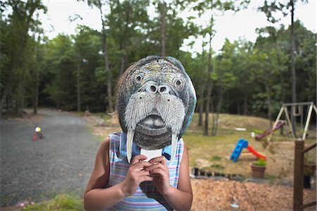 simsearch:700-02046160,k - Little Girl Wearing Animal Mask in Backyard Foto de stock - Con derechos protegidos, Código: 700-02702543