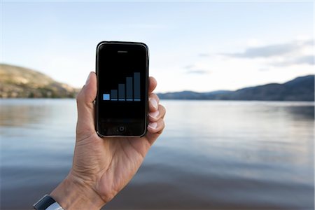 signal - Man Holding iPhone near Lake Stock Photo - Rights-Managed, Code: 700-02702586