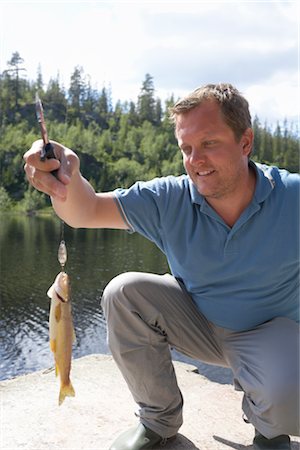 Man Catching Fish, Norway Stock Photo - Rights-Managed, Code: 700-02702604