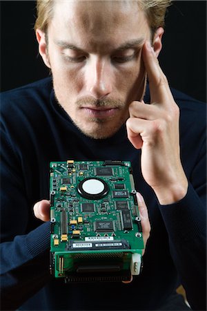 Close-up of Man holding Computer Circuit Board Stock Photo - Rights-Managed, Code: 700-02757154