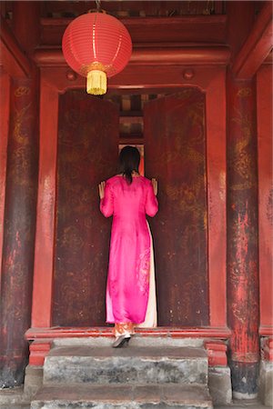 Backview of Woman Wearing Traditional Dress, Peeking through Door, Temple of Literature, Hanoi, Vietnam Stock Photo - Rights-Managed, Code: 700-02828404