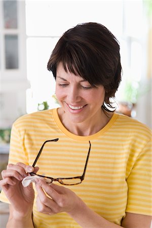 Woman Cleaning Her Glasses Stock Photo - Rights-Managed, Code: 700-02833568