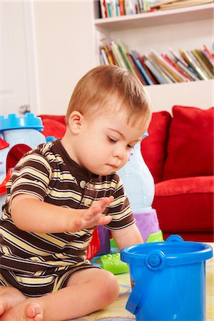 simsearch:700-00280017,k - Boy with Down Syndrom Sitting on Floor and Playing with Toy Stock Photo - Rights-Managed, Code: 700-02833637