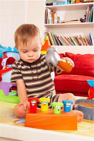 simsearch:700-00280017,k - Boy with Down Syndrom Sitting on Floor and Playing with Toy Stock Photo - Rights-Managed, Code: 700-02833638