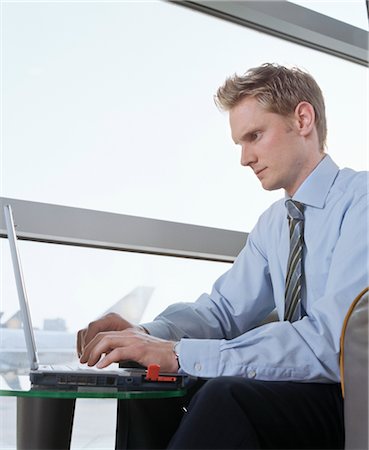 Businessman using Laptop at Airport Stock Photo - Rights-Managed, Code: 700-02887136