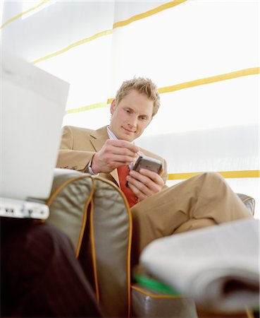 Businessman using Electronic Organizer in Airport Stock Photo - Rights-Managed, Code: 700-02887167