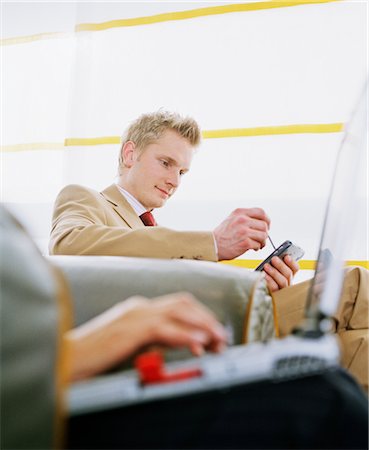 Businessman using Electronic Organizer in Airport Stock Photo - Rights-Managed, Code: 700-02887169