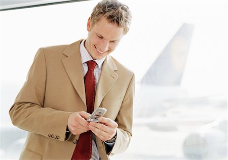 simsearch:700-03058969,k - Businessman using Cell Phone at Airport Stock Photo - Rights-Managed, Code: 700-02887170