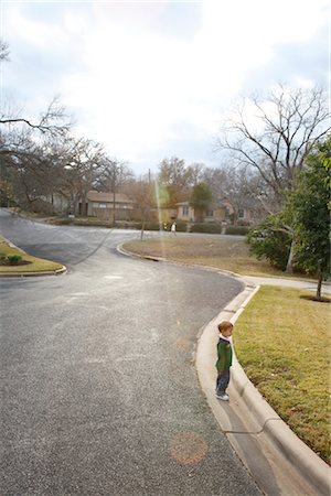 Boy Standing near Curb of Neighborhood Street, Austin, Texas, USA Stock Photo - Rights-Managed, Code: 700-02912121