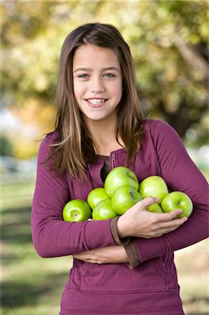 Girl Holding a Bunch of Apples Stock Photo - Rights-Managed, Code: 700-02922685