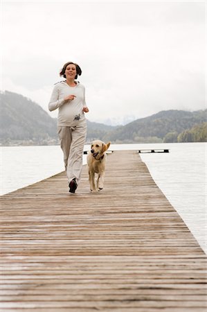 Pregnant Woman Running on Dock With Her Dog Stock Photo - Rights-Managed, Code: 700-02922749
