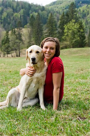 Pregnant Woman Sitting in Field With Her Dog Stock Photo - Rights-Managed, Code: 700-02922756