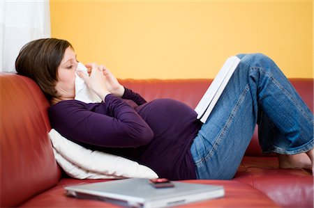 person blowing nose pic - Pregnant Woman Reading Book while Lying on Couch Stock Photo - Rights-Managed, Code: 700-02943317