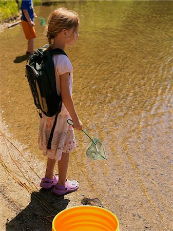 Girl With a Net Standing at Edge of Pond Stock Photo - Rights-Managed, Code: 700-02973265
