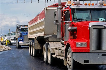 dump truck - Dump Trucks Lined Up at Road Construction Site for Paving, Calgary, Alberta, Canada Stock Photo - Rights-Managed, Code: 700-03053772