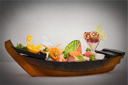 serving gourmet food - Sashimi and Sushi Rolls decorated in Serving Boat Stock Photo - Rights-Managed, Code: 700-03053866