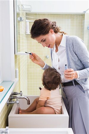 Mother with Baby Applying Make-up Stock Photo - Rights-Managed, Code: 700-03068740