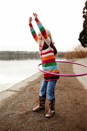 rubber boots in little girl - Girl Hula-hooping Stock Photo - Rights-Managed, Code: 700-03075866