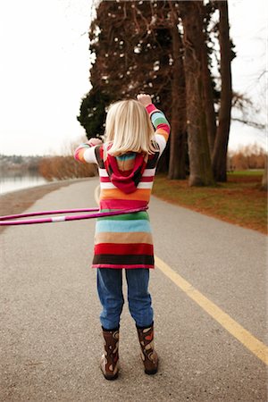 rubber boots in little girl - Girl Hula-hooping Stock Photo - Rights-Managed, Code: 700-03075863