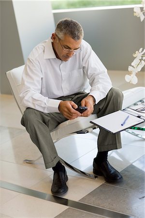 Man Using Cell Phone at Home Stock Photo - Rights-Managed, Code: 700-03228669
