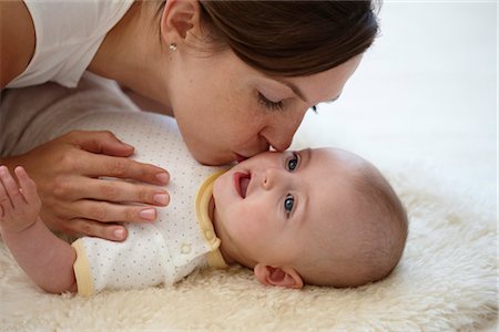 daughter kissing mother - Mother Playing with Baby Stock Photo - Rights-Managed, Code: 700-03294888