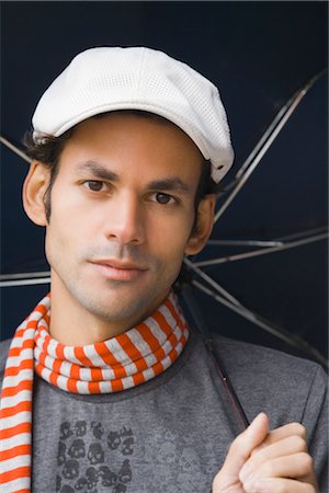 Close-up Portrait of Man wearing Hat and holding an Umbrella Stock Photo - Rights-Managed, Code: 700-03290301