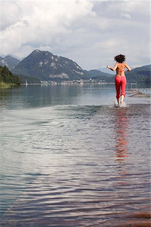 Woman Running Through Shallow Water, Fuschlsee, Salzburg, Austria, Stock Photo - Rights-Managed, Code: 700-03333145