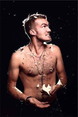 Man Covered in Feathers, Holding Two Birds in His Hand Stock Photo - Rights-Managed, Code: 700-03361645