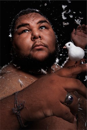Man Covered in Feathers, Holding Birds in His Hands Foto de stock - Con derechos protegidos, Código: 700-03361649