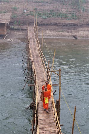 Monks Crossing Bridge over Nam Khan River, Luang Prabang, Laos Stock Photo - Rights-Managed, Code: 700-03407730