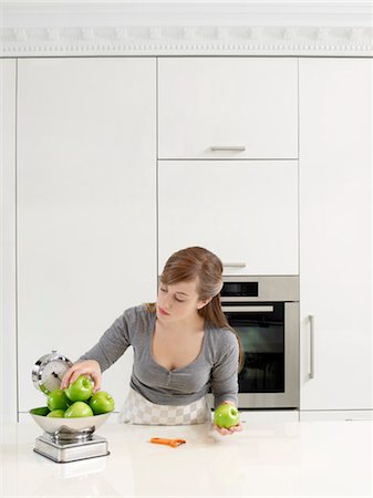 person on weigh scale - Young Woman Weighing Apples Stock Photo - Rights-Managed, Code: 700-03407945