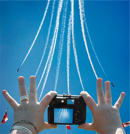 Women's Hands Holding Digital Camera, Taking Picture of Snowbirds at Air Show, CNE, Toronto, Ontario, Canada Stock Photo - Rights-Managed, Code: 700-03403781