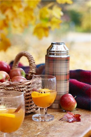 Thermos with Apple Cider and Basket of Apples Stock Photo - Rights-Managed, Code: 700-03439608