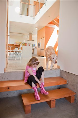 rubber boots in little girl - Girl Putting on Rubber Boots Stock Photo - Rights-Managed, Code: 700-03455675