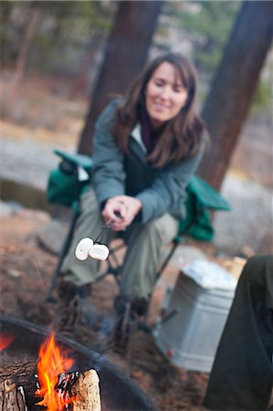 sitting by fire pit - Woman Roasting Marshmallows over Campfire, Truckee, near Lake Tahoe, California, USA Stock Photo - Rights-Managed, Code: 700-03503047