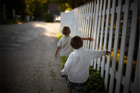 friend on road boy - Boys Walking Beside White Picket Fence, Sauble Beach, Ontario, Canada Stock Photo - Rights-Managed, Code: 700-03520592