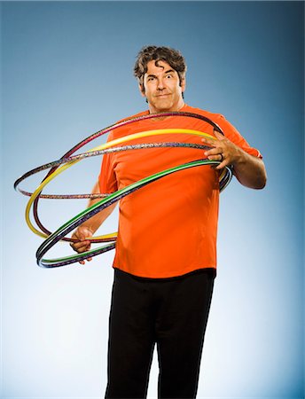 shape toys - Man With Hula Hoops Looking Confused Stock Photo - Rights-Managed, Code: 700-03638639