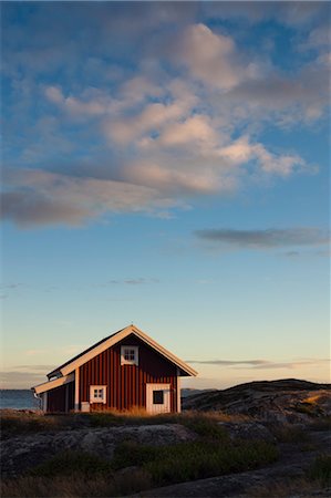 Red Wooden Hut on Shoreline, Bohuslaen, Vastra Gotaland County, Gotaland, Sweden Stock Photo - Rights-Managed, Code: 700-03685782