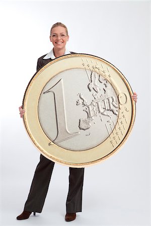 executive standing white background - Femme d'affaires détenant la grande pièce de monnaie Euro Photographie de stock - Rights-Managed, Code: 700-03685807