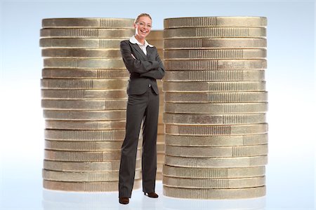 rich women with money laughing - Businesswoman Standing in front of Stacks of Large Coins Stock Photo - Rights-Managed, Code: 700-03685808