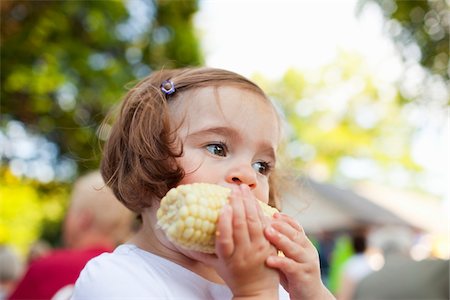 Little Girl Eating Cob of Corn Stock Photo - Rights-Managed, Code: 700-03696885