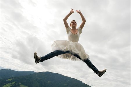 Girl Wearing Ballerina Dress Jumping into Air Stock Photo - Rights-Managed, Code: 700-03777745