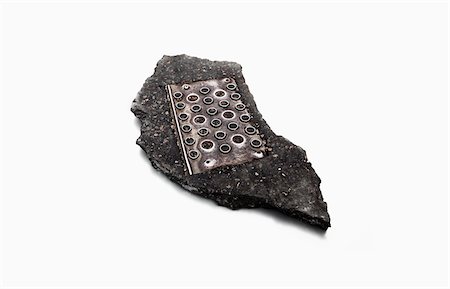 Old Metal Plate Embeddeed in Road Bitumen Stock Photo - Rights-Managed, Code: 700-03777887