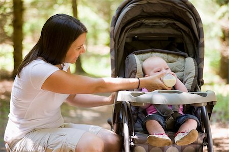 simsearch:700-07199763,k - Mother Feeding Baby Girl in Stroller Outdoors in Forest Stock Photo - Rights-Managed, Code: 700-03787165