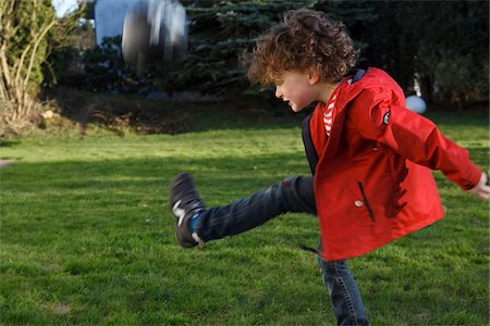 Boy Kicking Ball Foto de stock - Con derechos protegidos, Código: 700-03783329