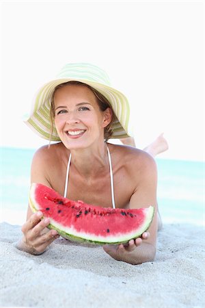 swimwear for mature women - Woman Eating Watermelon on Beach Stock Photo - Rights-Managed, Code: 700-03814255