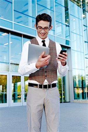 suit man eyeglasses - Businessman Holding Cell Phone and Tablet PC Stock Photo - Rights-Managed, Code: 700-03814370
